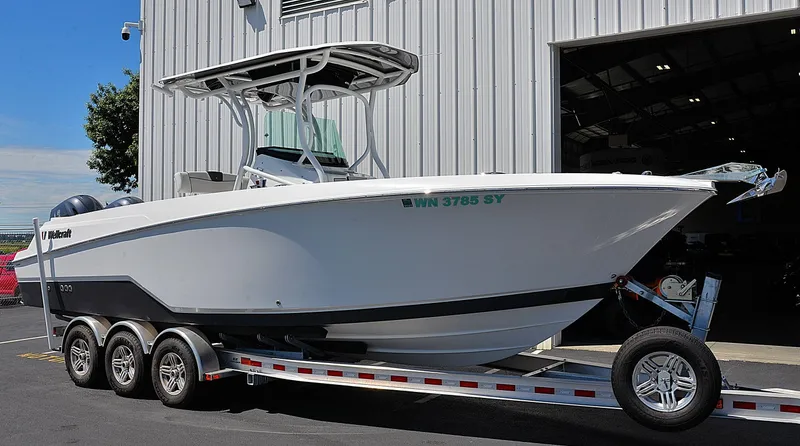 The Image of 2021 Wellcraft 262 Fisherman boat on trailer, parked outside a metal building. - 1