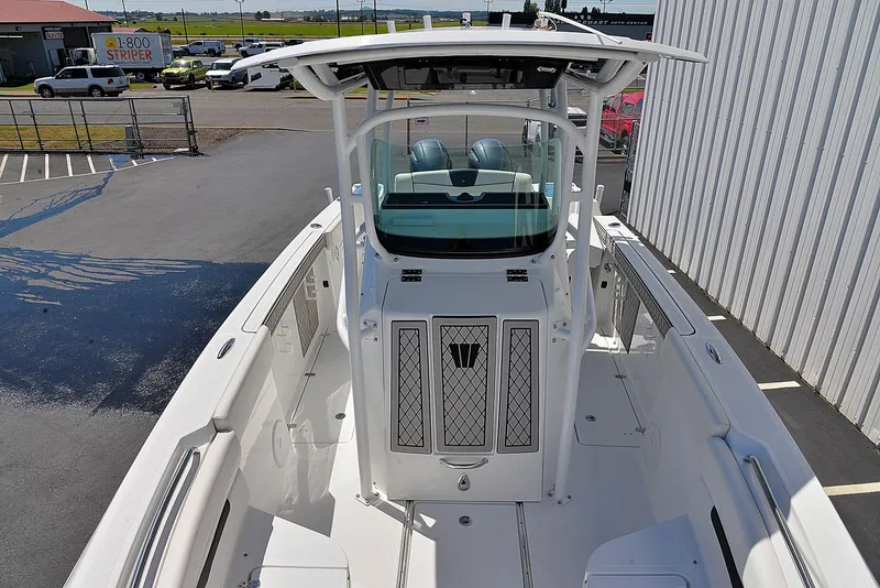 Slide: The Image of 2021 Wellcraft 262 Fisherman boat, white deck, center console, parked outdoors. - 6