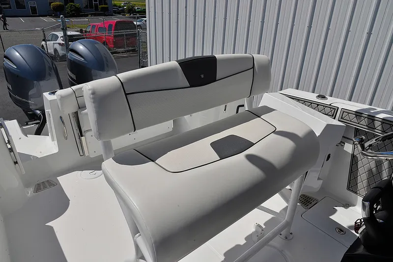 Slide: The Image of 2021 Wellcraft 262 Fisherman boat seating area with dual engines in a marina setting. - 9