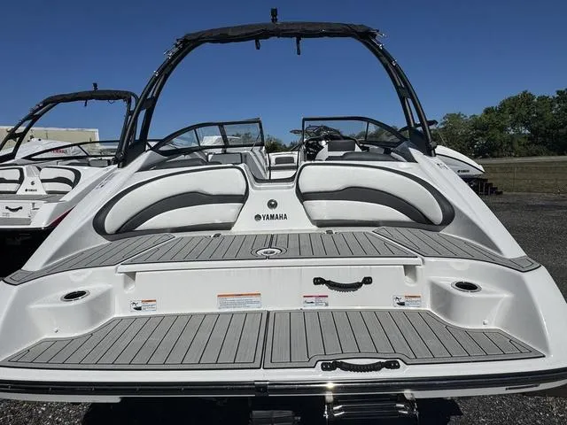 Slide: The Image of 2025 Yamaha AR195 boat, rear view, sleek design, spacious seating, outdoor setting. - 4