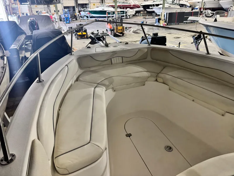 Slide: The Image of 2012 Carolina Skiff Sea Chaser 2400 Offshore boat interior with cushioned seating in a showroom. - 11