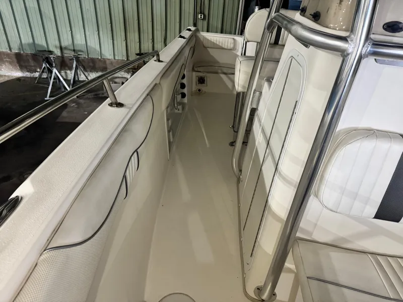 Slide: The Image of 2012 Carolina Skiff Sea Chaser 2400 Offshore boat interior with seating and stainless steel railings. - 13