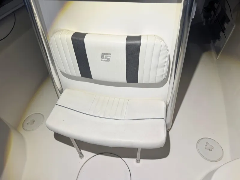 Slide: The Image of 2012 Carolina Skiff Sea Chaser 2400 Offshore boat seat with white and black upholstery. - 15