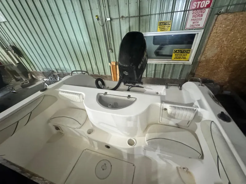Slide: The Image of 2012 Carolina Skiff Sea Chaser 2400 Offshore boat interior with engine, in storage facility. - 4