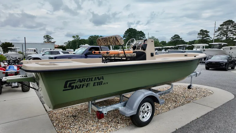 Slide: The Image of 2025 Carolina Skiff E18 JVX Swamp Edition boat on trailer, outdoor display. - 10