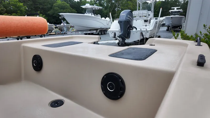 Slide: The Image of 2025 Carolina Skiff E18 JVX Swamp Edition boat with motor, docked outdoors. - 3