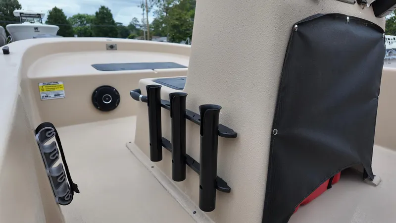 Slide: The Image of 2025 Carolina Skiff E18 JVX Swamp Edition boat interior with rod holders and storage. - 4