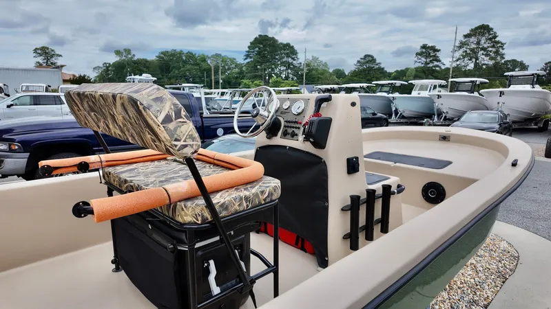 Slide: The Image of 2025 Carolina Skiff E18 JVX Swamp Edition boat with camo seats and steering console. - 9