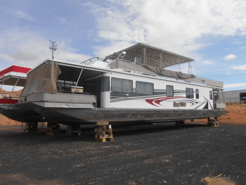 The Image of 1994 Stardust Cruisers houseboat on land, featuring a spacious upper deck and modern design. - 0