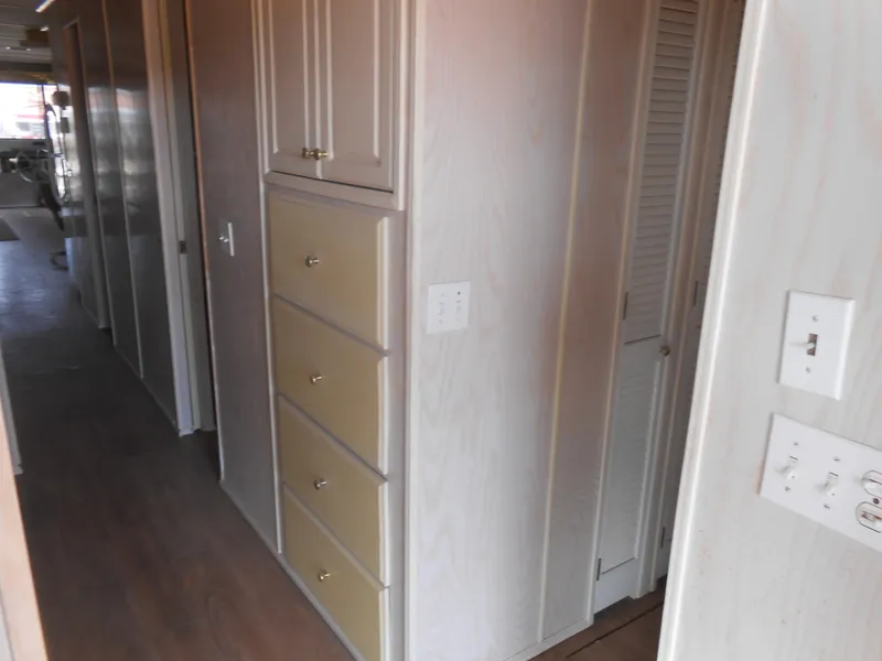 Slide: The Image of Interior hallway of a 1994 Stardust Cruisers houseboat with wooden cabinets and light switches. - 19