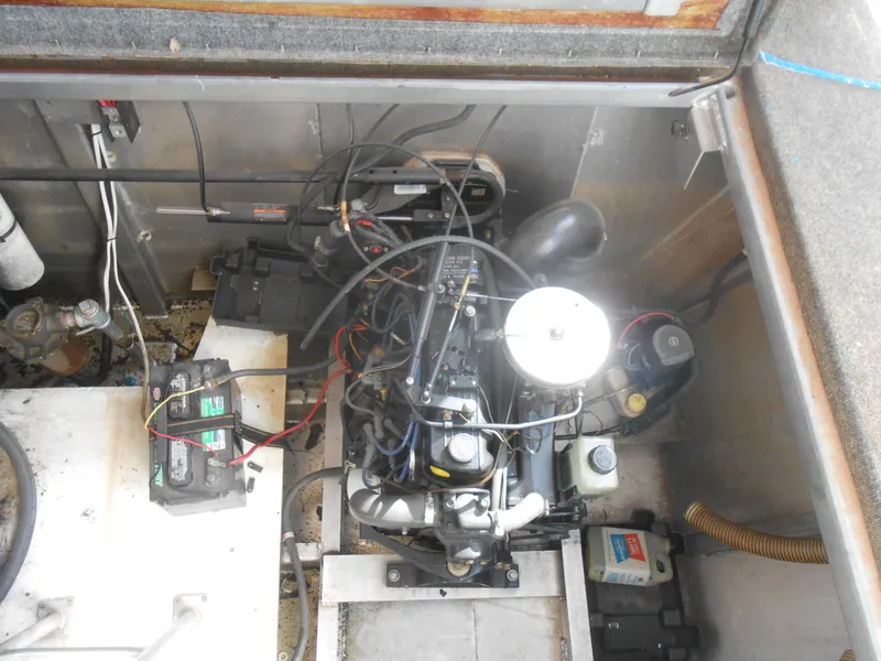 Slide: The Image of Engine compartment of a 1994 Stardust Cruisers houseboat, showing engine and battery setup. - 27