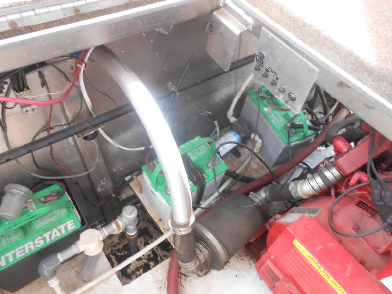 Slide: The Image of 1994 Stardust Cruisers houseboat engine compartment with batteries and wiring. - 29