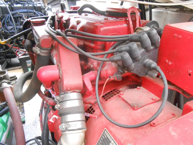 Slide: The Image of Red engine of a 1994 Stardust Cruisers houseboat, showcasing detailed components and wiring. - 30
