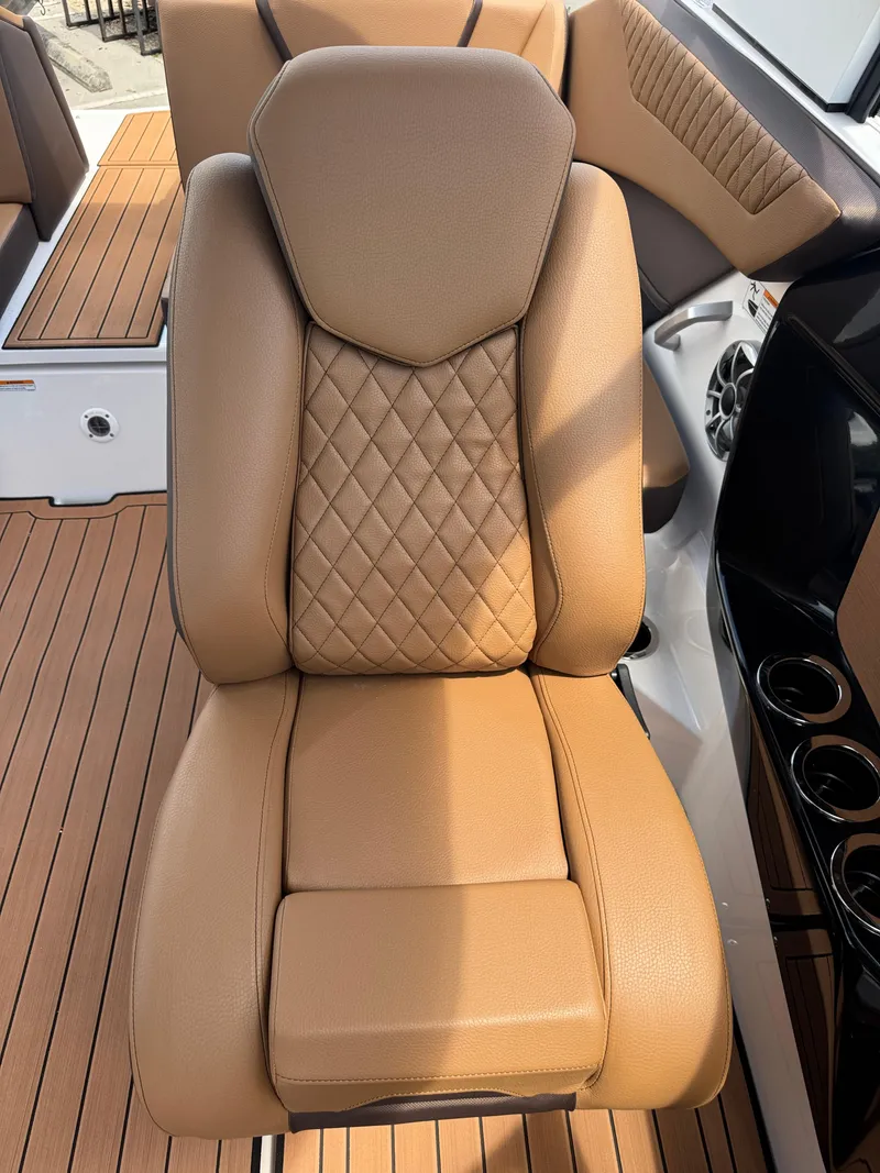 Slide: The Image of Luxurious tan seat on 2025 Yamaha Boats 222S, featuring diamond stitching and sleek design. - 12