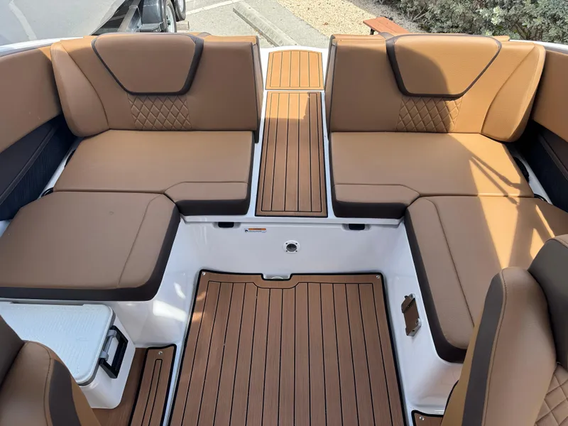 Slide: The Image of 2025 Yamaha Boats 222S interior with brown cushioned seating and wood-style flooring. - 14