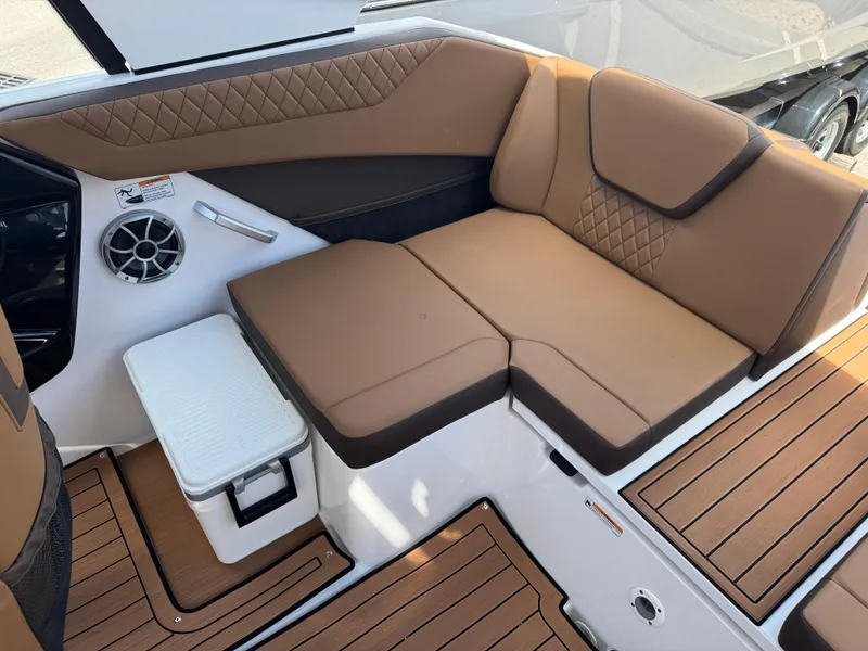 Slide: The Image of 2025 Yamaha Boats 222S interior with brown seating and integrated speaker system. - 15
