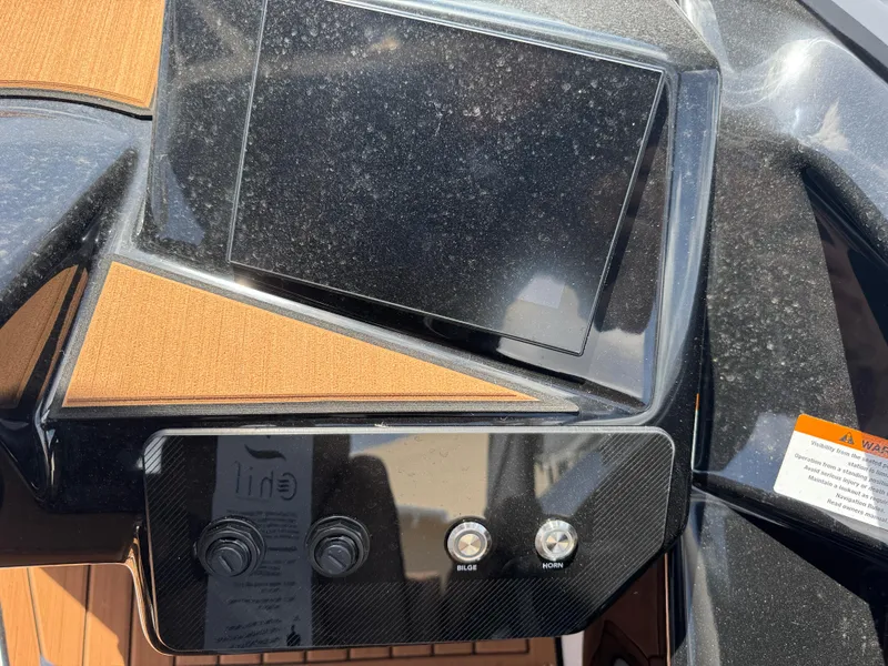 Slide: The Image of Control panel of 2025 Yamaha Boats 222S with touchscreen and switches. - 19