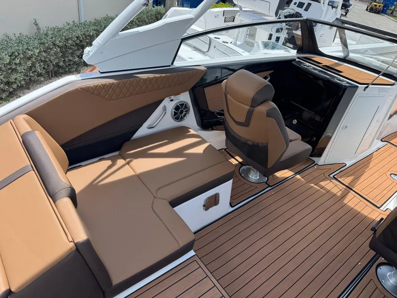 Slide: The Image of 2025 Yamaha Boats 222S interior with brown seating and sleek design. - 2
