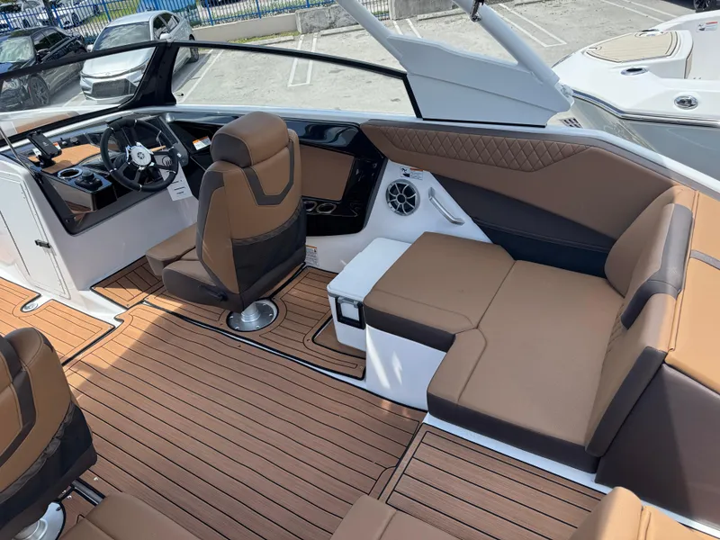 Slide: The Image of 2025 Yamaha Boats 222S interior with brown seating and modern dashboard design. - 3