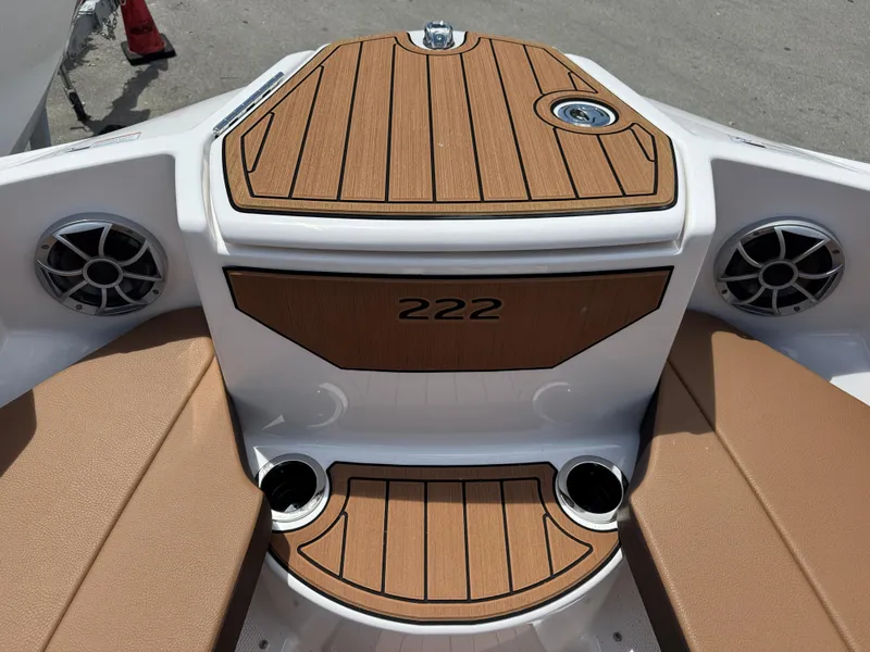Slide: The Image of 2025 Yamaha Boats 222S interior with wood accents and speaker system. - 6