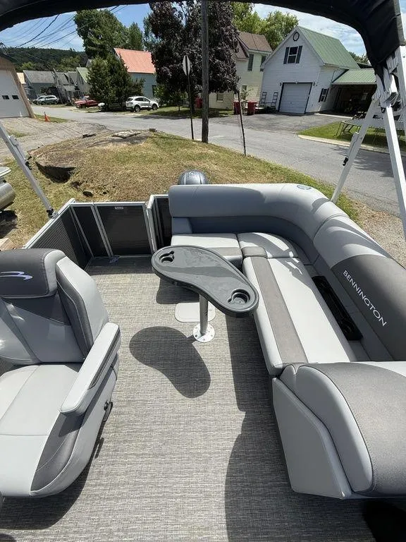 Slide: The Image of 2025 Bennington S L-Bench 18SVL pontoon boat interior with gray seating and table. - 17