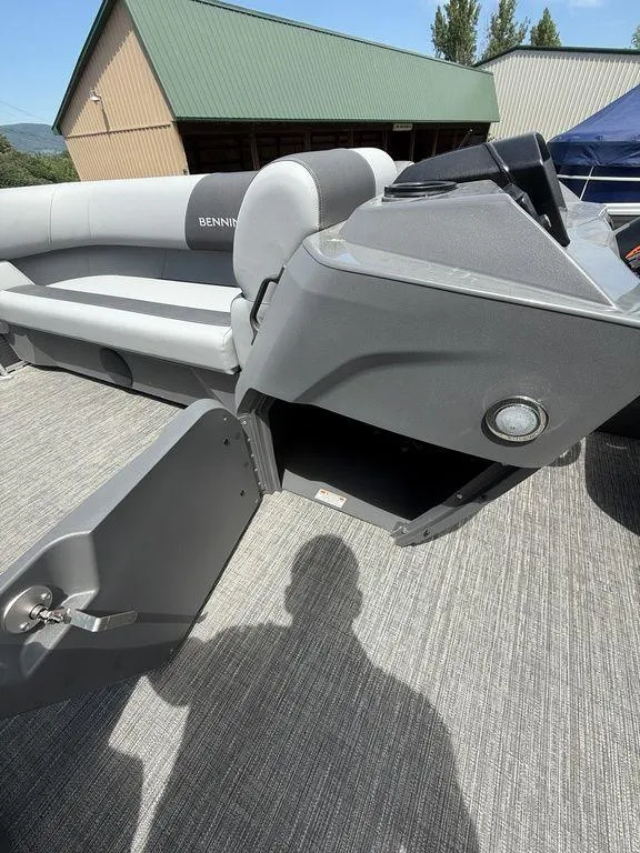 Slide: The Image of 2025 Bennington S L-Bench 18SVL boat interior with open storage compartment. - 19