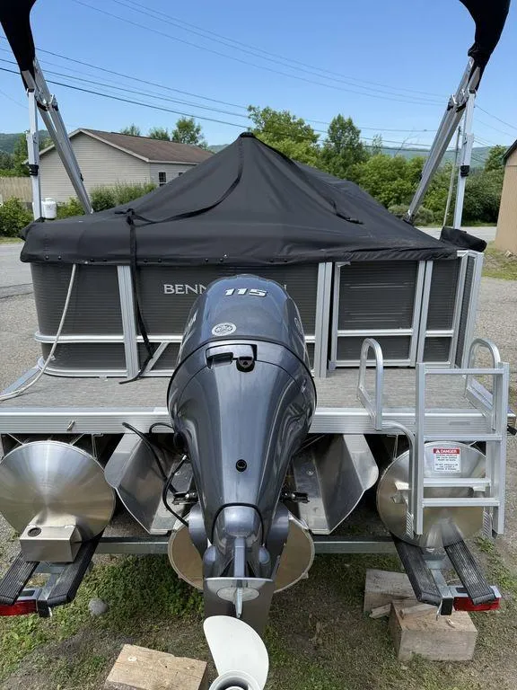 Slide: The Image of 2025 Bennington S L-Bench 18SVL pontoon boat with outboard motor and cover. - 5