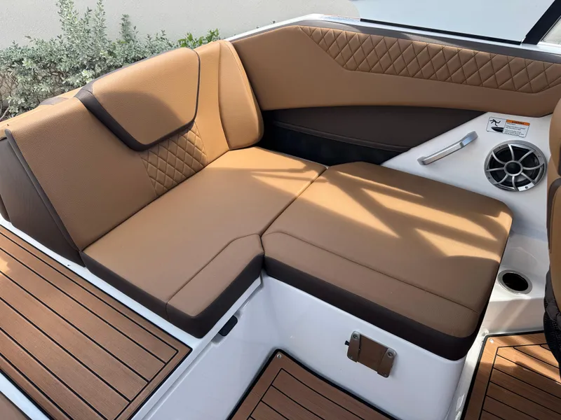 Slide: The Image of Luxurious seating on 2025 Yamaha Boats 222S, featuring tan upholstery and sleek design. - 13