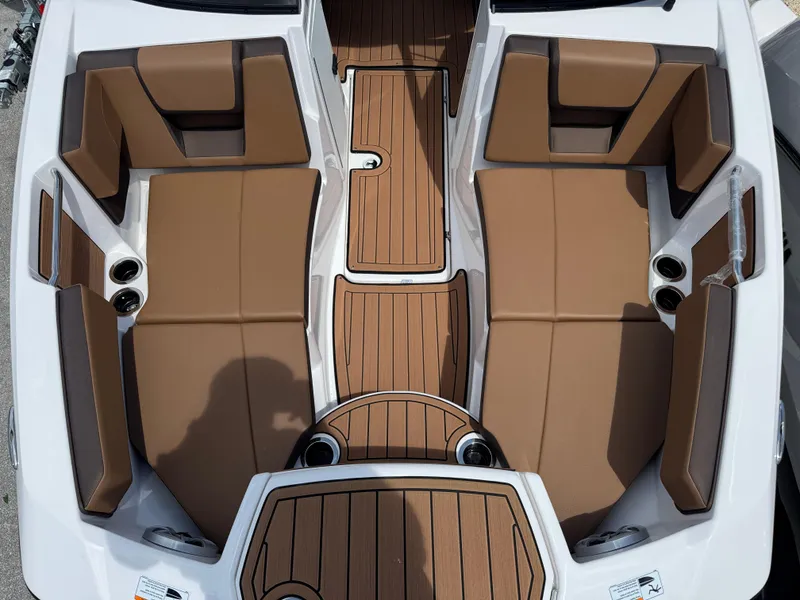 Slide: The Image of 2025 Yamaha Boats 222S interior with brown seating and wood-style flooring. - 8