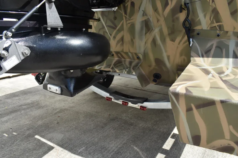 Slide: The Image of 2025 Lowe RX1860 Tunnel Jet boat with camouflage design and jet propulsion system. - 10