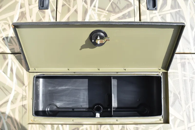 Slide: The Image of Open storage compartment of 2025 Lowe RX1860 Tunnel Jet boat, featuring a secure latch. - 14