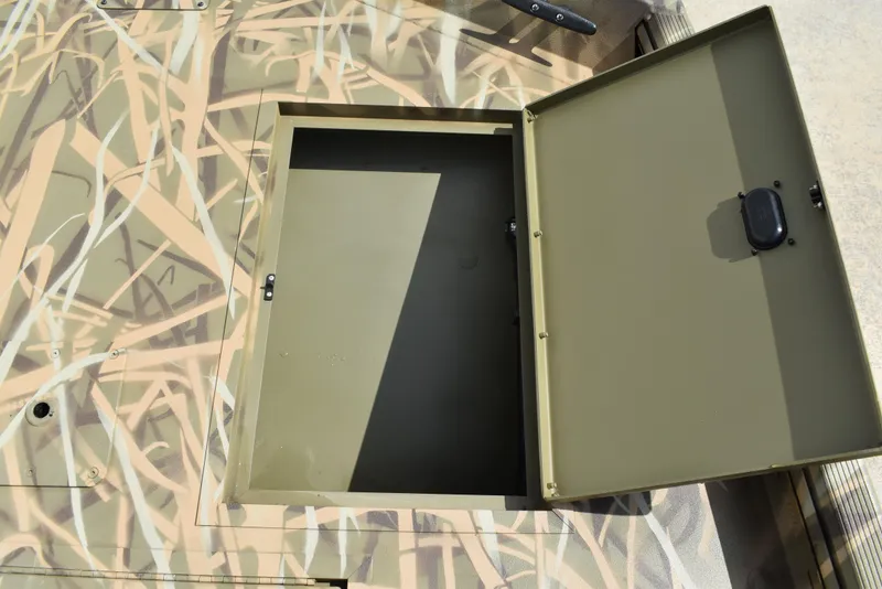 Slide: The Image of Open storage compartment on 2025 Lowe RX1860 Tunnel Jet boat with camouflage design. - 15