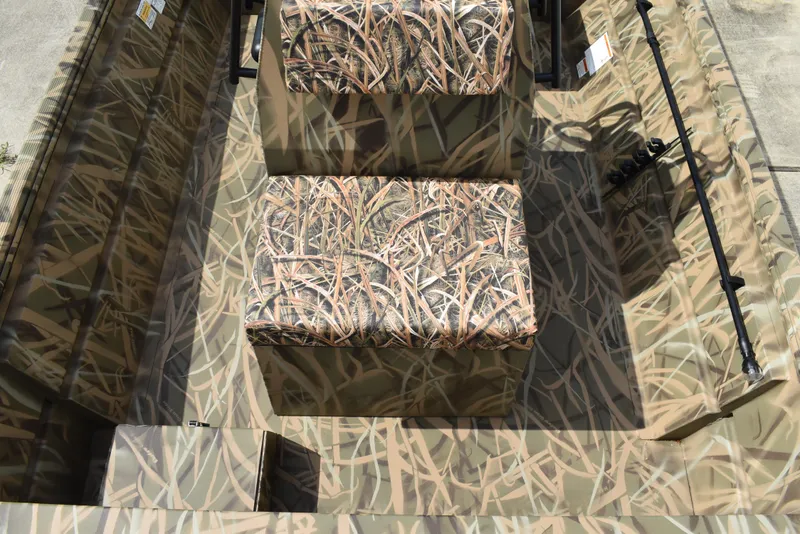 Slide: The Image of 2025 Lowe RX1860 Tunnel Jet boat interior with camouflage seating and flooring. - 18