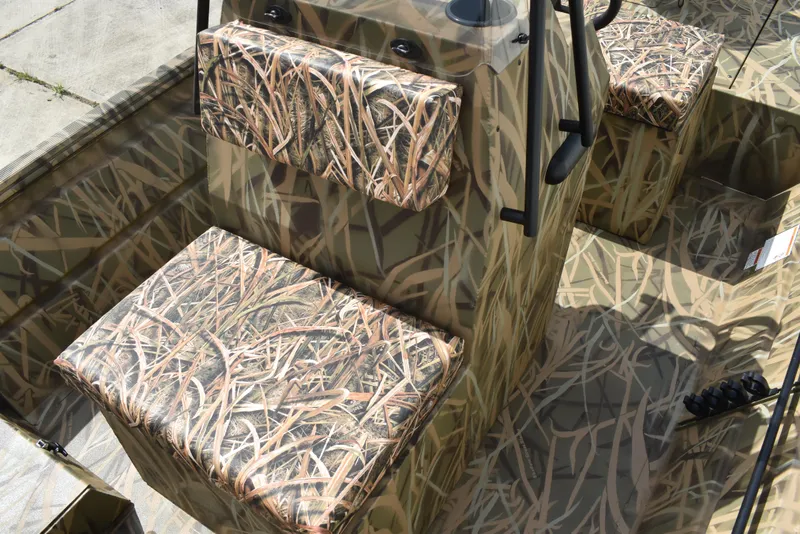 Slide: The Image of 2025 Lowe RX1860 Tunnel Jet boat interior with camouflage seating and design. - 20