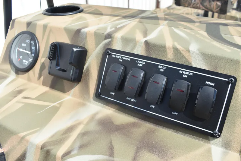 Slide: The Image of Control panel of 2025 Lowe RX1860 Tunnel Jet boat with switches and gauge. - 22