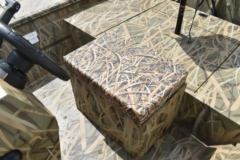 Slide: The Image of 2025 Lowe RX1860 Tunnel Jet boat with camouflage seating and steering wheel. - 23