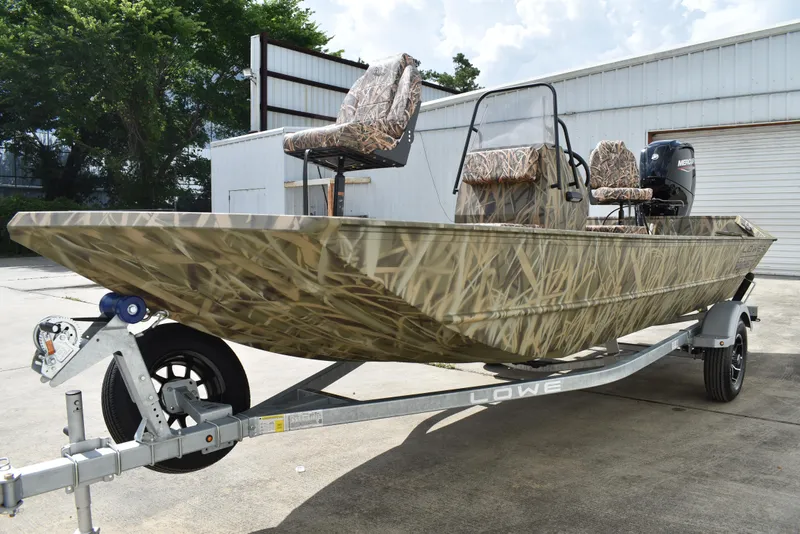 Slide: The Image of 2025 Lowe RX1860 Tunnel Jet boat with camouflage design on a trailer. - 4