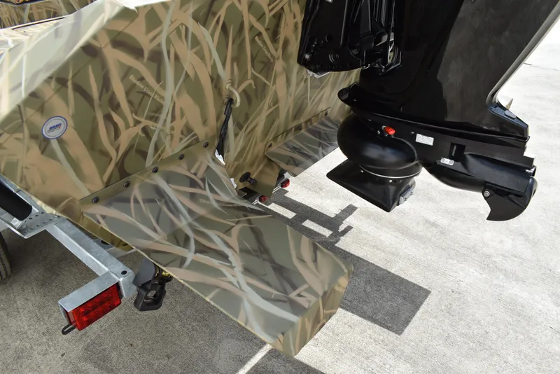 Slide: The Image of Camouflage-patterned Lowe RX1860 Tunnel Jet boat, 2025 model, with outboard motor detail. - 6