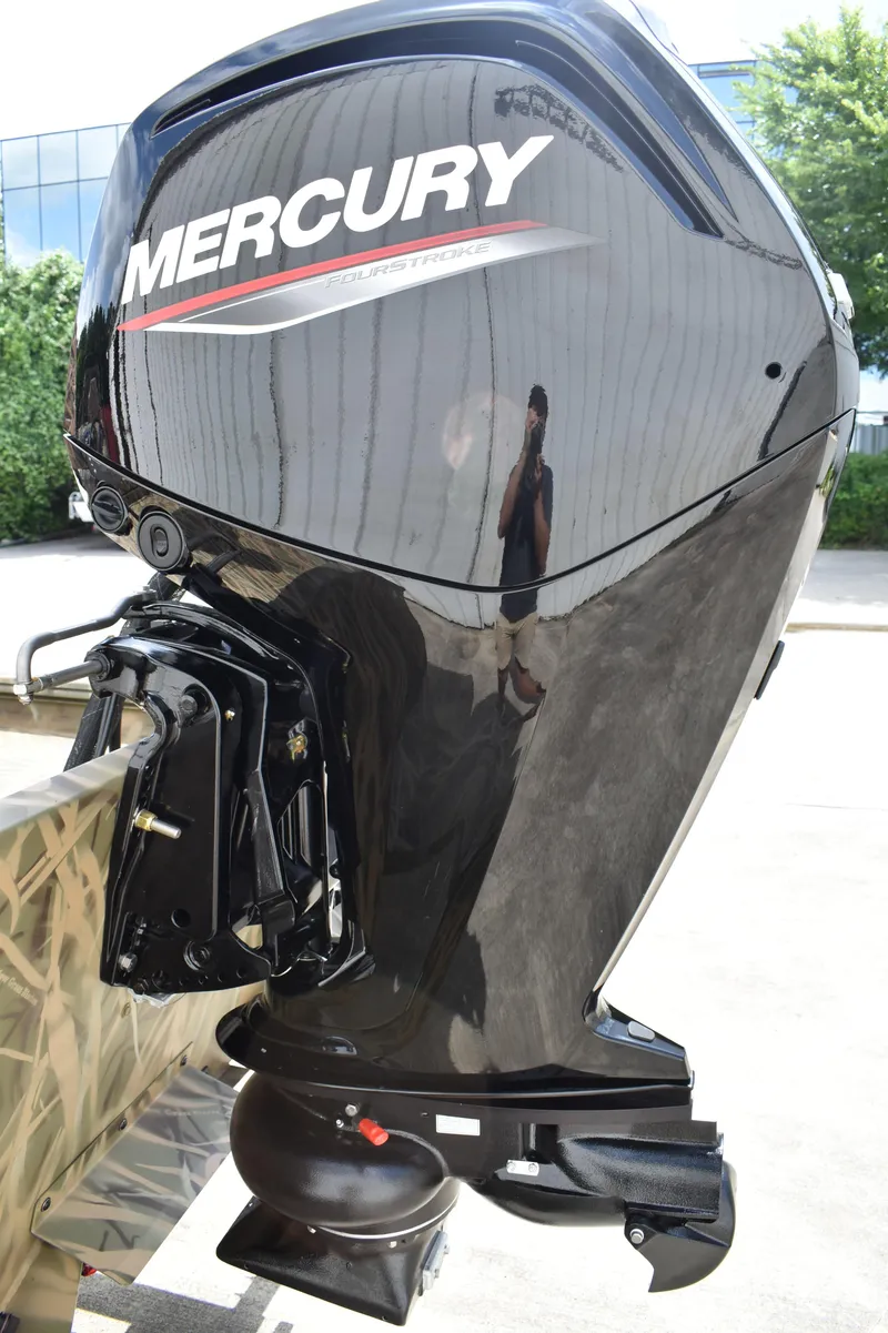 Slide: The Image of 2025 Lowe RX1860 Tunnel Jet with Mercury FourStroke outboard motor, outdoor setting. - 7