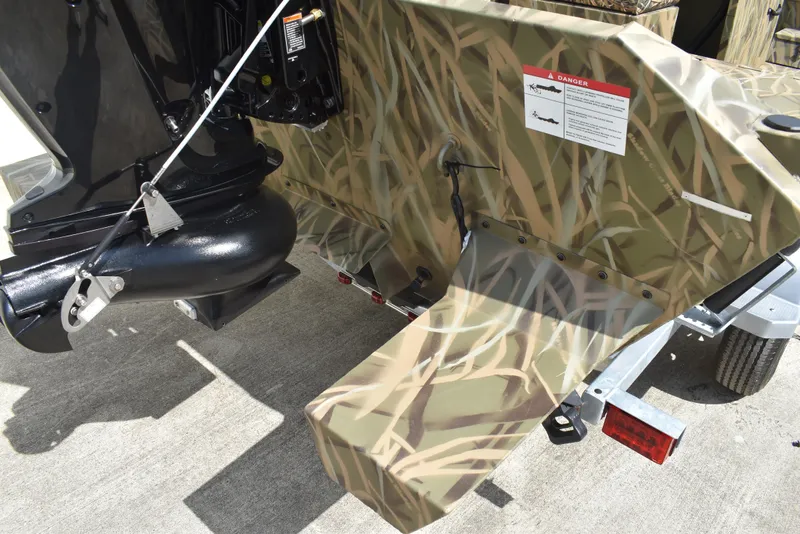 Slide: The Image of 2025 Lowe RX1860 Tunnel Jet boat with camouflage design and jet propulsion system. - 9