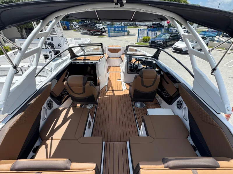 Slide: The Image of 2025 Yamaha Boats 222S interior with brown seating, sleek design, and spacious layout. - 1
