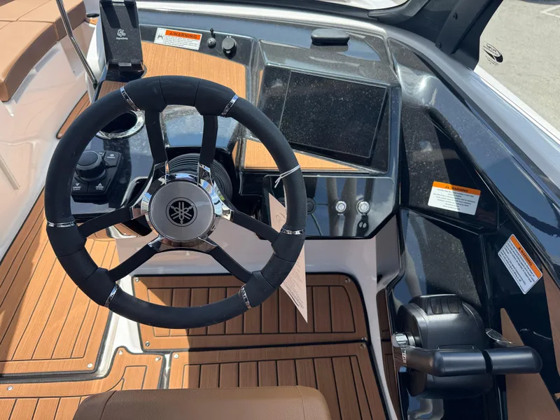 Slide: The Image of 2025 Yamaha Boats 222S dashboard with steering wheel and control panel. - 18
