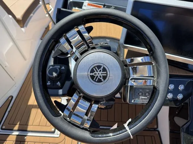 Slide: The Image of Steering wheel of 2025 Yamaha Boats 222SD, featuring sleek design and modern controls. - 17