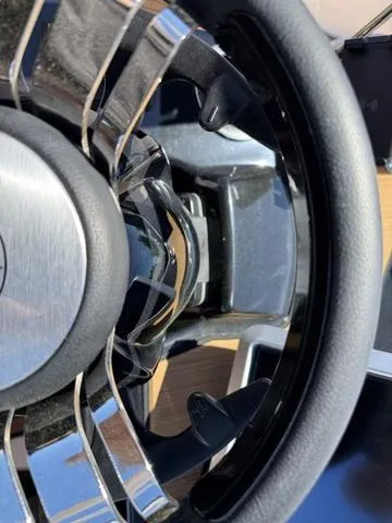 Slide: The Image of Close-up of 2025 Yamaha Boats 222SD steering wheel, showcasing sleek design and chrome accents. - 19