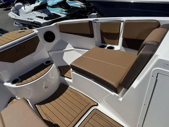 Slide: The Image of 2025 Yamaha Boats 222SD interior with brown seating and wood accents. - 21