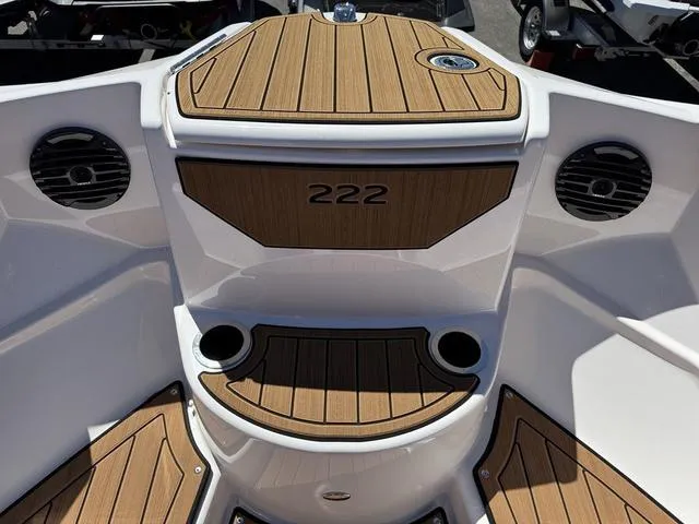 Slide: The Image of 2025 Yamaha Boats 222SD interior with wood accents and cup holders. - 23