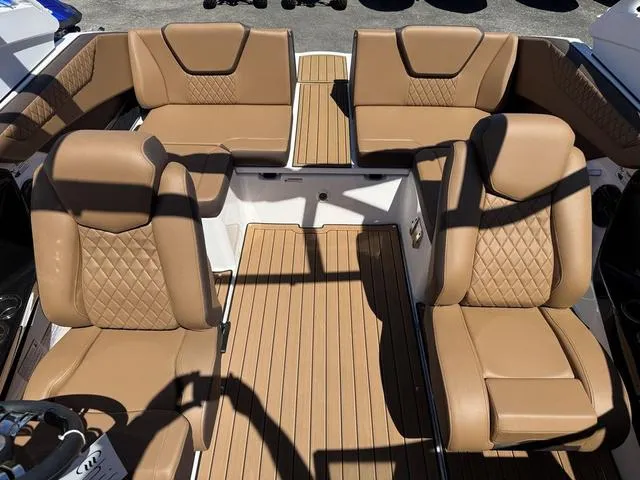 Slide: The Image of Luxurious interior of 2025 Yamaha Boats 222SD with tan leather seating and wood flooring. - 29