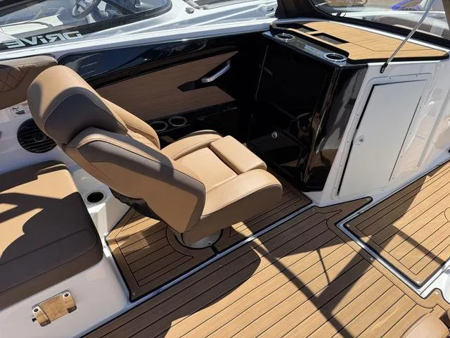 Slide: The Image of 2025 Yamaha Boats 222SD interior with tan seating and sleek wood finish. - 8