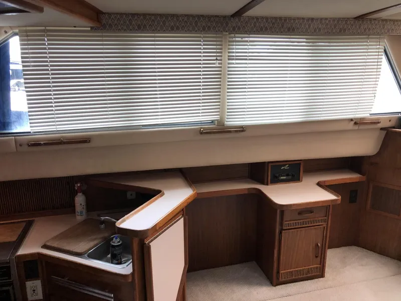 Slide: The Image of 1987 Sea Ray 360 Aft Cabin interior with wood cabinetry and blinds. - 13
