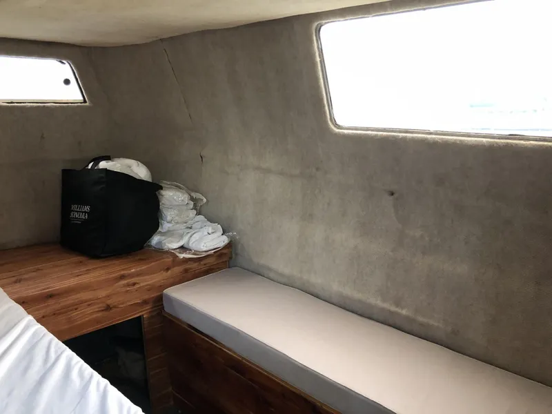 Slide: The Image of 1987 Sea Ray 360 Aft Cabin interior with wooden surfaces and seating area. - 15